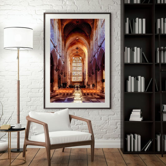 Framed photograph of a cathedral interior in a living room setting with a chair and lamp.