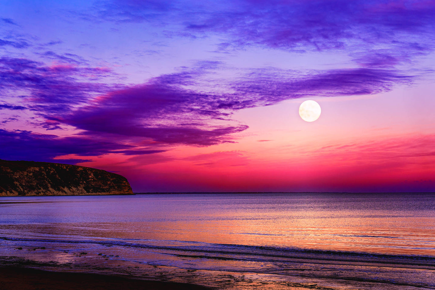 Moonrise Over Swanage Bay, at sunset, in Swanage, United Kingdom, with cool light on cloud