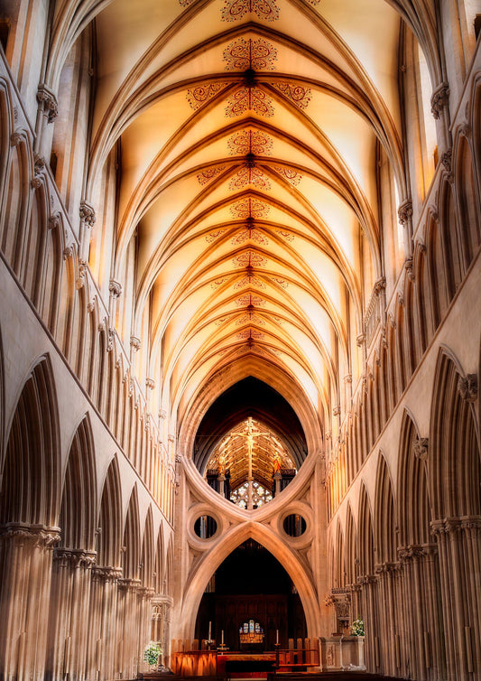 Golden scissor arches inside Wells Cathedral glowing in warm morning light, fine art photography by John Wright