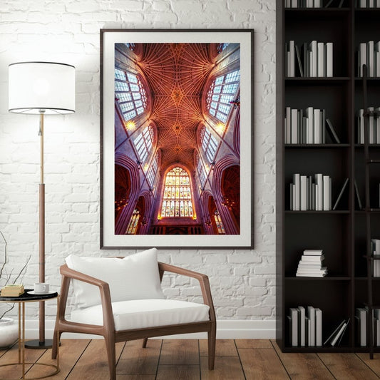 Framed artwork of a cathedral ceiling in a living room setting with a chair and lamp.