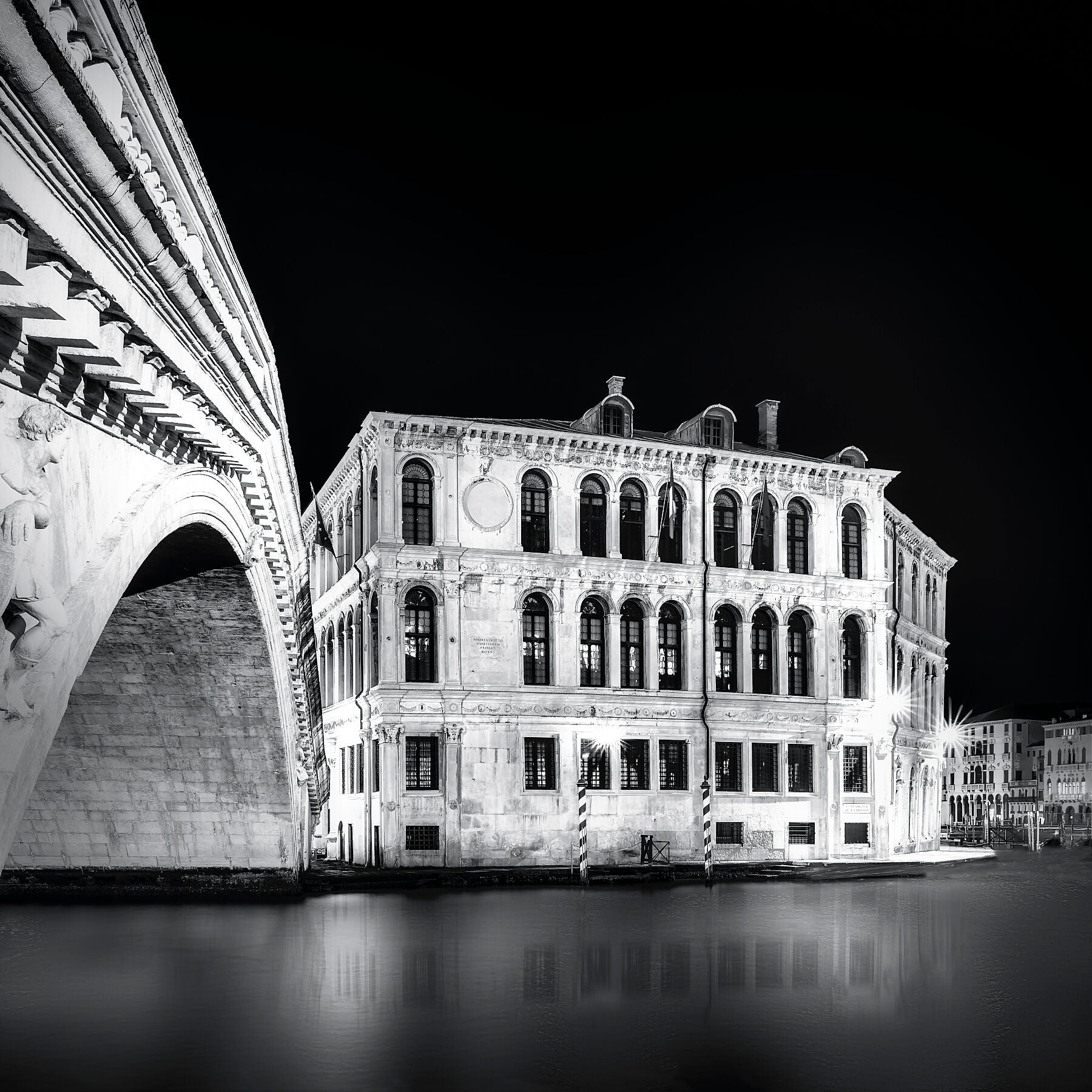 Underneath the Rialto Bridge in Venice—archways, shadows, and flowing reflections.