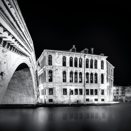 Underneath the Rialto Bridge in Venice—archways, shadows, and flowing reflections.