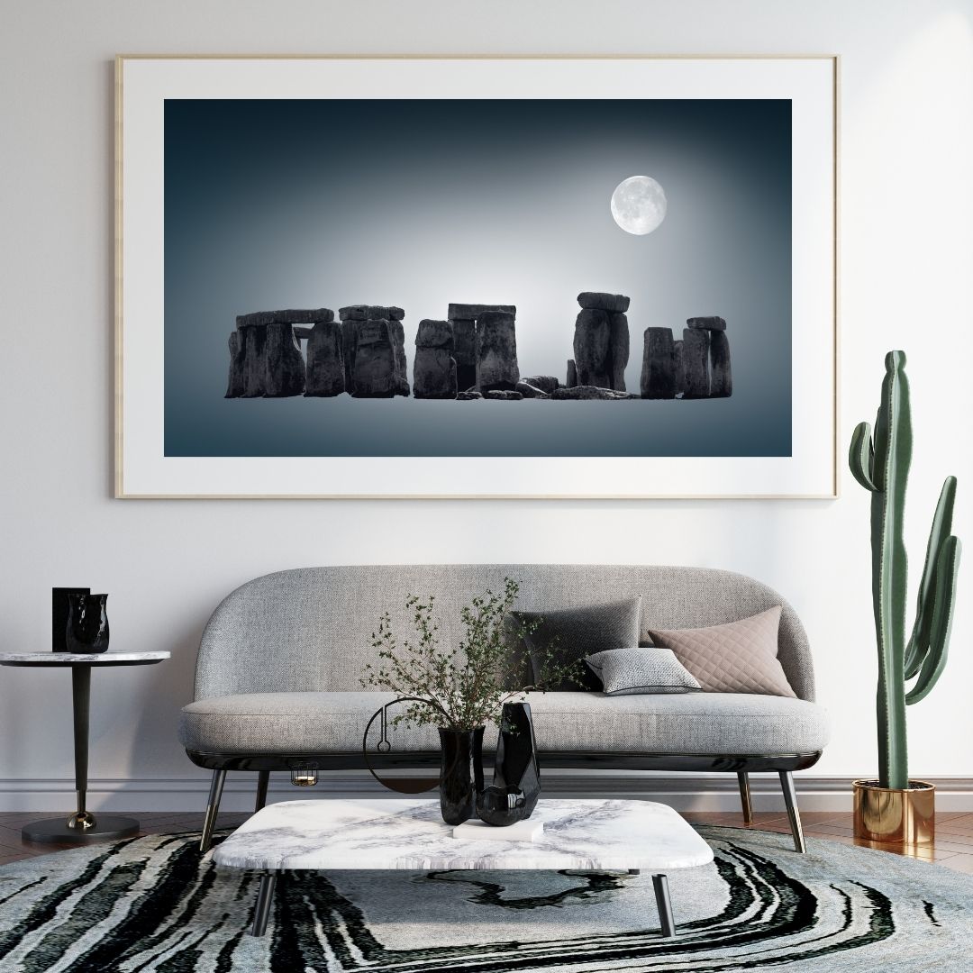 Framed artwork of Stonehenge under a moonlit sky in a modern living room.