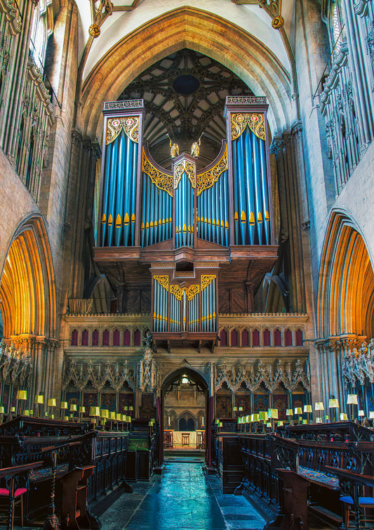 The main organ of Wells Cathedral with choir stall in the foreground.