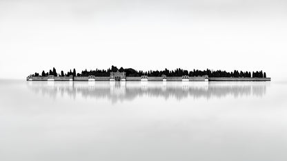 Black and white minimalist photograph of San Michele cemetery island in Venice, reflected in still water with architectural detail and cypress trees.