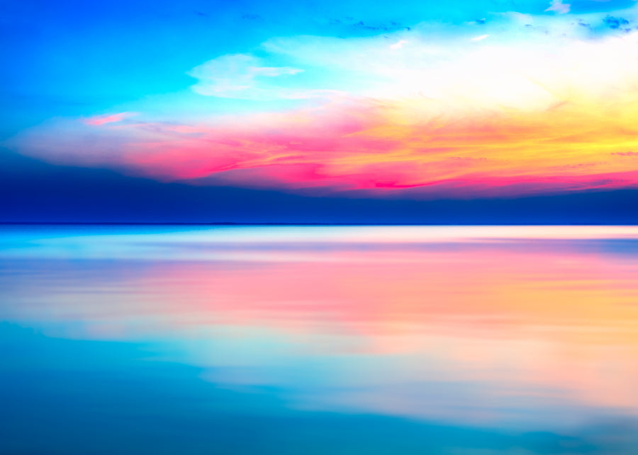 Abstract sunrise seascape with soft blended colours and a calm horizon created using long exposure