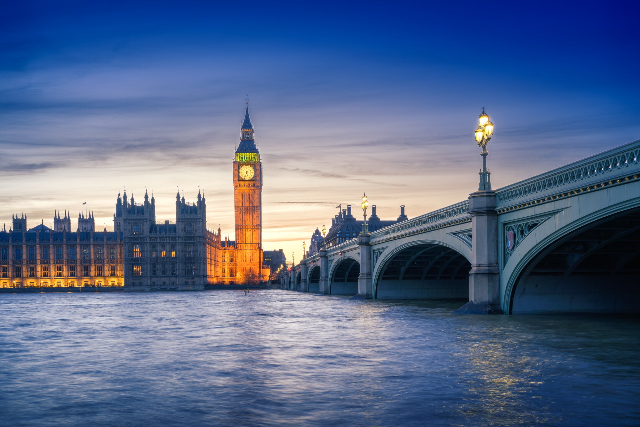 Colour photograph of Big Ben and Westminster at sunset with Westminster Bridge and the River Thames in London